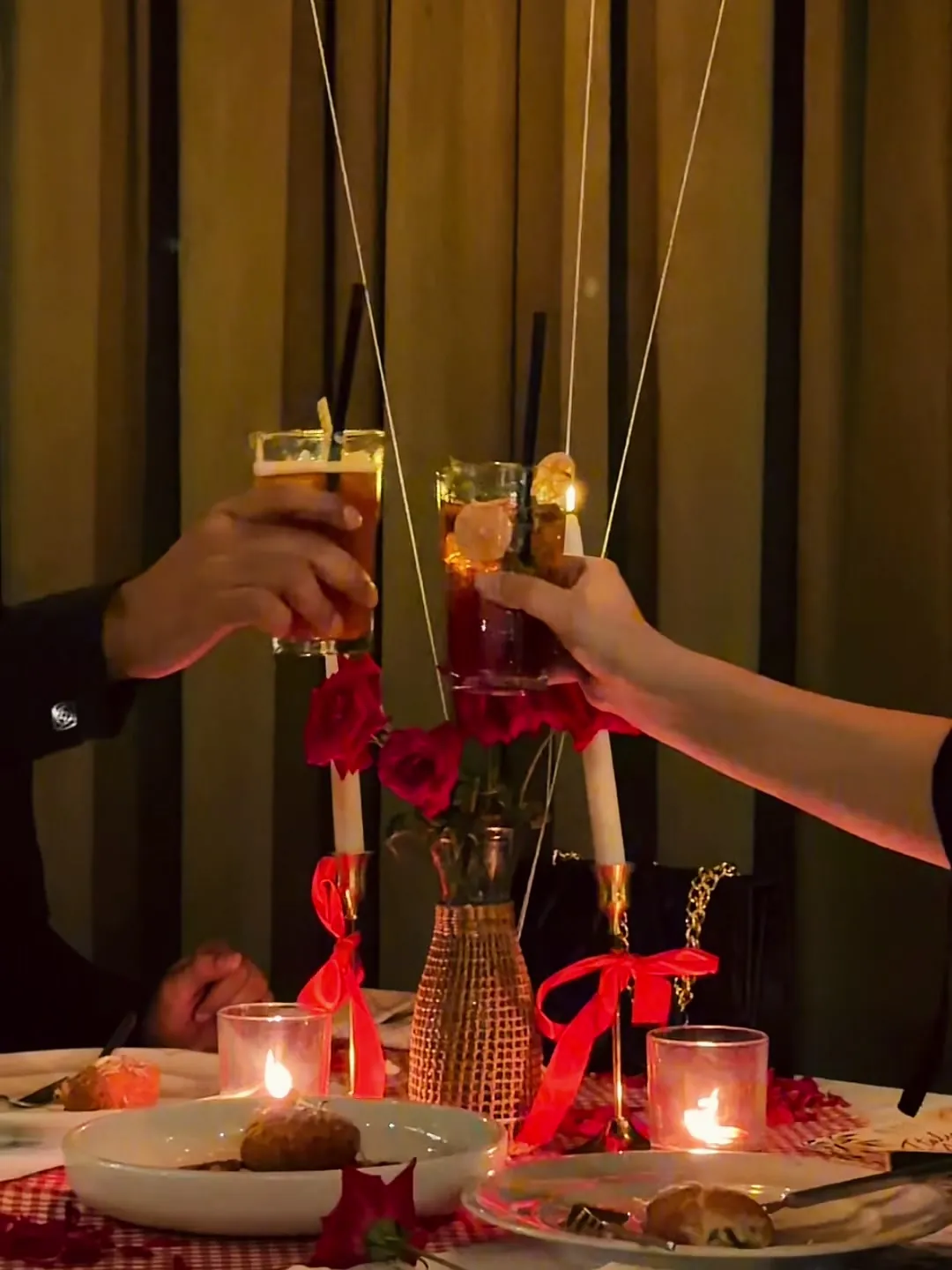 Two glasses of the house cooler raised over the Date Club table